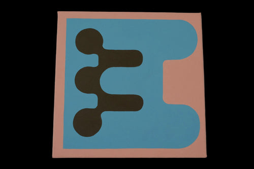 A square abstract art print or canvas featuring a minimalist geometric design with a peach border, a large light blue shape, and three dark brown circular and rectangular elements, displayed against a neutral gray wall.